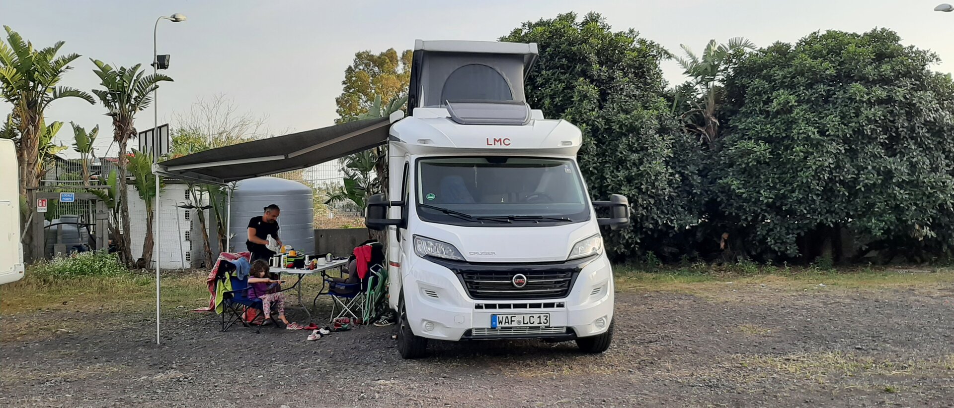 Familie am Essenstisch im freien unter ausgefahrenem LMC Camper Dack