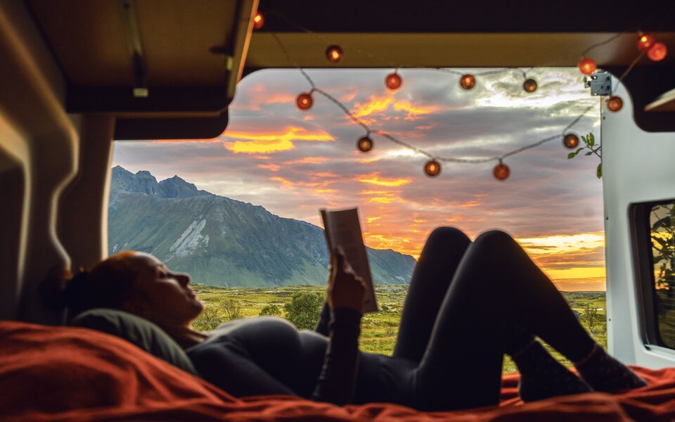 Frau liegt im Bett des LMC Innovans Active und ließt ein Buch